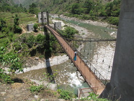 i8252w_blue-village-lady-on-foot-bridge-near-thal